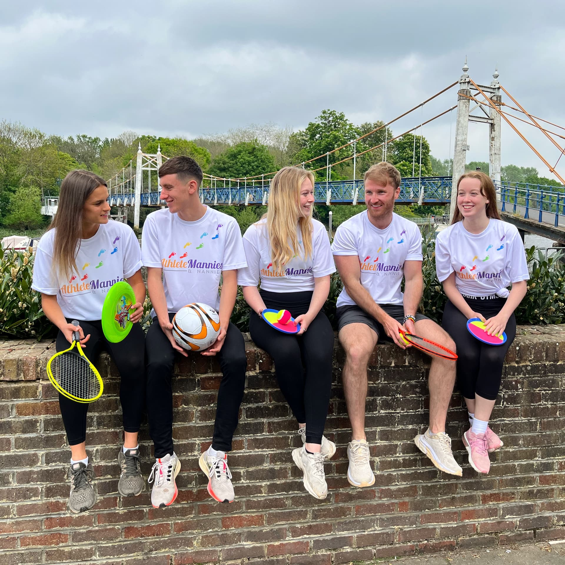 Athlete Mannies & Nannies team with sports equipment by Teddington Lock footbridge